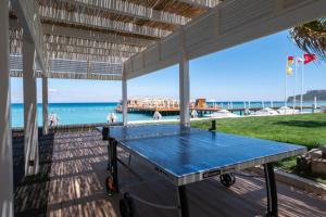 a ping pong table on a porch overlooking the beach at Corendon Hydros Club Kemer - Ultra All Inclusive in Kemer