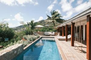 a swimming pool in the backyard of a house at 3 Bedroom Villa with Lagoon View Pool in Marigot