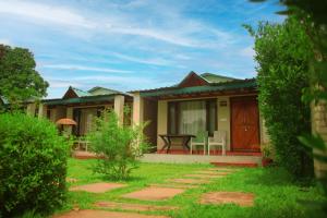 a house with a table and chairs in the yard at Entire Farm house in Jim Corbett with staff and cook in Rāmnagar