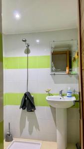 a bathroom with a sink and a mirror at Martil, Avenue Oum Kalthoum in Martil +2 photos