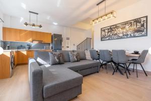 a living room with a couch and a table with chairs at Ski Lodge Sierra Nevada in Sierra Nevada +30 photos