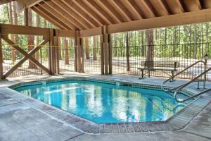 a swimming pool in a pavilion with a bench at Pinetop Resort Studio Apartment in Pinetop-Lakeside