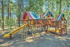 a wooden playground with a slide and a slideintend at Pinetop Resort Studio Apartment in Pinetop-Lakeside