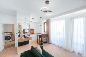 a living room with a green couch and a table at Victory SeaSide Studio in Mangalia