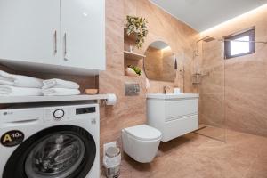 a bathroom with a washing machine and a toilet at Victory SeaSide Studio in Mangalia +54 photos