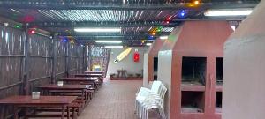 a dining room with wooden tables and white chairs at Apartment on doonside Beach in Kingsborough