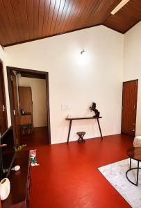 a living room with a table on the wall at Priyaman Retreat in Madikeri