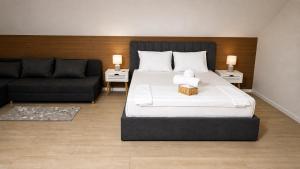 a bedroom with a large bed and a couch at Adori Apartment in Eforie Nord