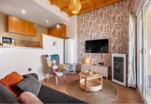 a living room with a couch and a table at Ski Lodge Sierra Nevada in Sierra Nevada