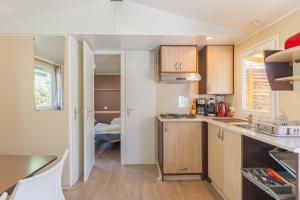 a kitchen with a sink and a counter top at Mobil-home Le 154 aux Iscles in La Roque-dʼAnthéron +12 photos