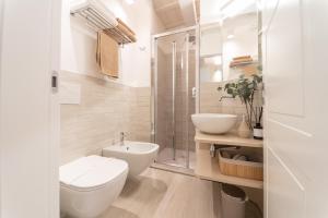 a bathroom with a toilet and a sink and a shower at Residenza Isotta in Rimini