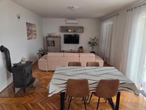 a living room with a couch and a table and chairs at Apartments Valiza III Large apartment - 3 bedrooms and parking space i Apartments Valiza IV in Senj