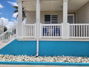 a house with a blue swimming pool in front of a house at Vista Azul Apartment in Punta Santiago +7 photos