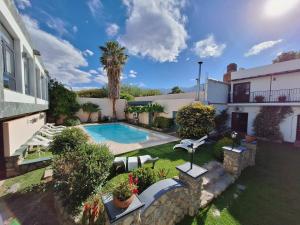an aerial view of a house with a swimming pool at Hotel Los Sauces in Cafayate
