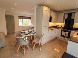 a kitchen and dining room with a table and chairs at 11 The Forge in Brampton