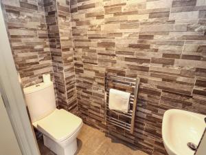 a bathroom with a toilet and a sink at 11 The Forge in Brampton +27 photos