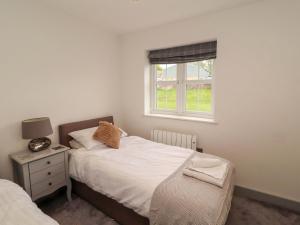 a bedroom with two beds and a window at 11 The Forge in Brampton