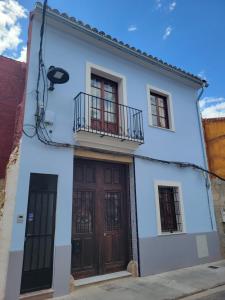 a white house with two doors and a balcony at Casa ALFANG in Torrent