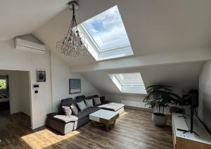 a living room with a couch and two skylights at Au 10 in St. Wolfgang