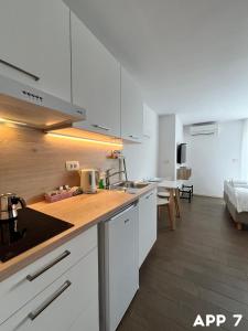 a kitchen with white cabinets and a counter top at Casa Maly in Portorož