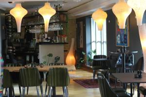 a dining room with tables and chairs and lights at 66 Guldsmeden in Copenhagen +65 photos