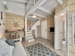 a room with a staircase and a living room at Home Sereia in Trebisacce