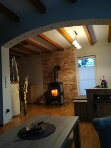 a living room with a wood stove in a room at Ferienhaus am Radweg in Brotterode-Trusetal