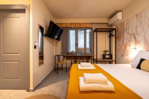 a hotel room with a bed with towels on it at L anima II in Skiathos