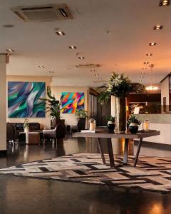 a lobby with a table with plants on it at Kalyon Hotel Istanbul in Istanbul