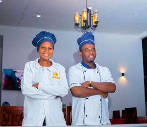two chefs standing next to each other with their arms crossed at CHAMBO VILLAS in Morogoro +46 photos