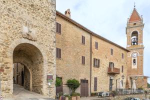a large brick building with a clock tower at Italian Experience-La Terrazza nel Borgo in Marsciano
