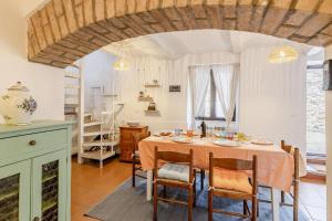 a kitchen and dining room with a table and chairs at Italian Experience-La Terrazza nel Borgo in Marsciano
