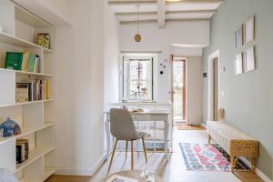 a home office with a desk and a chair at Italian Experience-La Terrazza nel Borgo in Marsciano