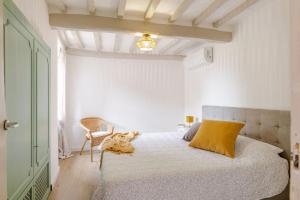 a bedroom with a bed with a yellow pillow at Italian Experience-La Terrazza nel Borgo in Marsciano