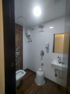 a bathroom with a toilet and a sink at Hotel Toss n Sipp Powai in Mumbai
