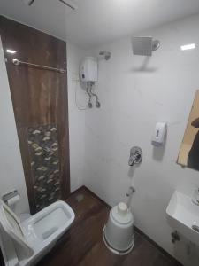 a bathroom with a toilet and a sink at Hotel Toss n Sipp Powai in Mumbai