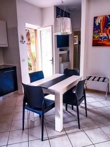 a dining room table and chairs in a kitchen at Casa di Luga in Costa Paradiso +26 photos