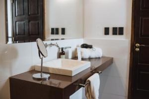 a bathroom with a sink and a mirror at Casa Entonada - Hotel Boutique in Chacras de Coria +33 photos