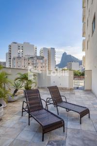 two chairs on a balcony with a view of a city at Lobie Botafogo Privilege in Rio de Janeiro