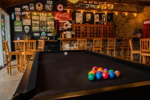 a pool table in a bar with balls on it at Fazenda Castanheira in Monte Verde