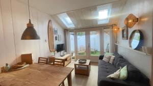 a living room with a blue couch and a table at Kust 3 in Egmond aan Zee