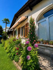 a house with flowers in front of a house at Lake View Palm Garden in Lugano