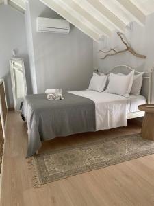 a bedroom with a large bed with white pillows at Fedon in Halki
