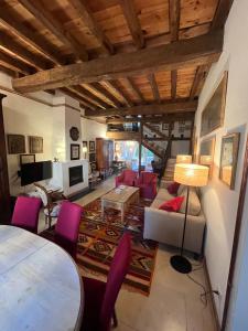 a living room with pink chairs and a table at La Fernandina in Riaza