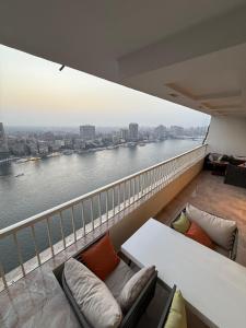 a balcony of a building with a view of a river at Nile Royale Hotel in Cairo