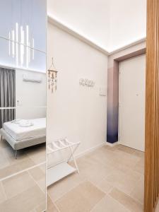 a room with a bed and a glass door at Luxury Way Blue Essence in Molfetta