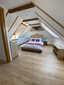 a bedroom with a large bed in a attic at Mackenzie Cottage, Kinlochbervie in Oldshore