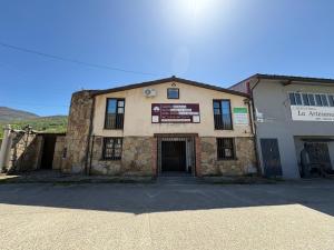 an old stone building with a sign on it at Camino Real in Jerte