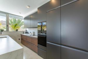 a kitchen with gray cabinets and a counter top at Villa Coco in Mogán