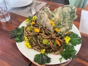 a plate of food with flowers on a table at La Locanda Di Cadì in Petralia Soprana